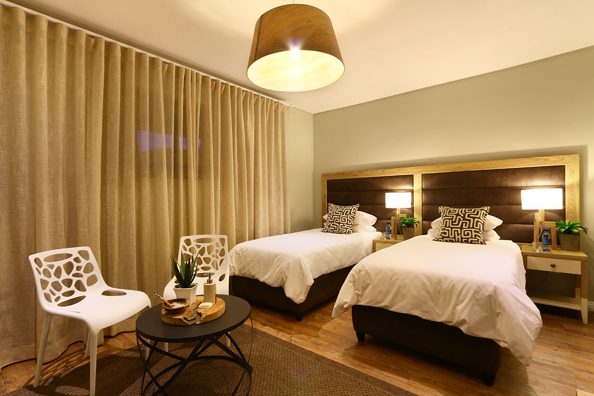 Aquila Standard Lodge Rooms: Picture showing twin beds in a standard lodge room as part of Aquila's accommodation options.
