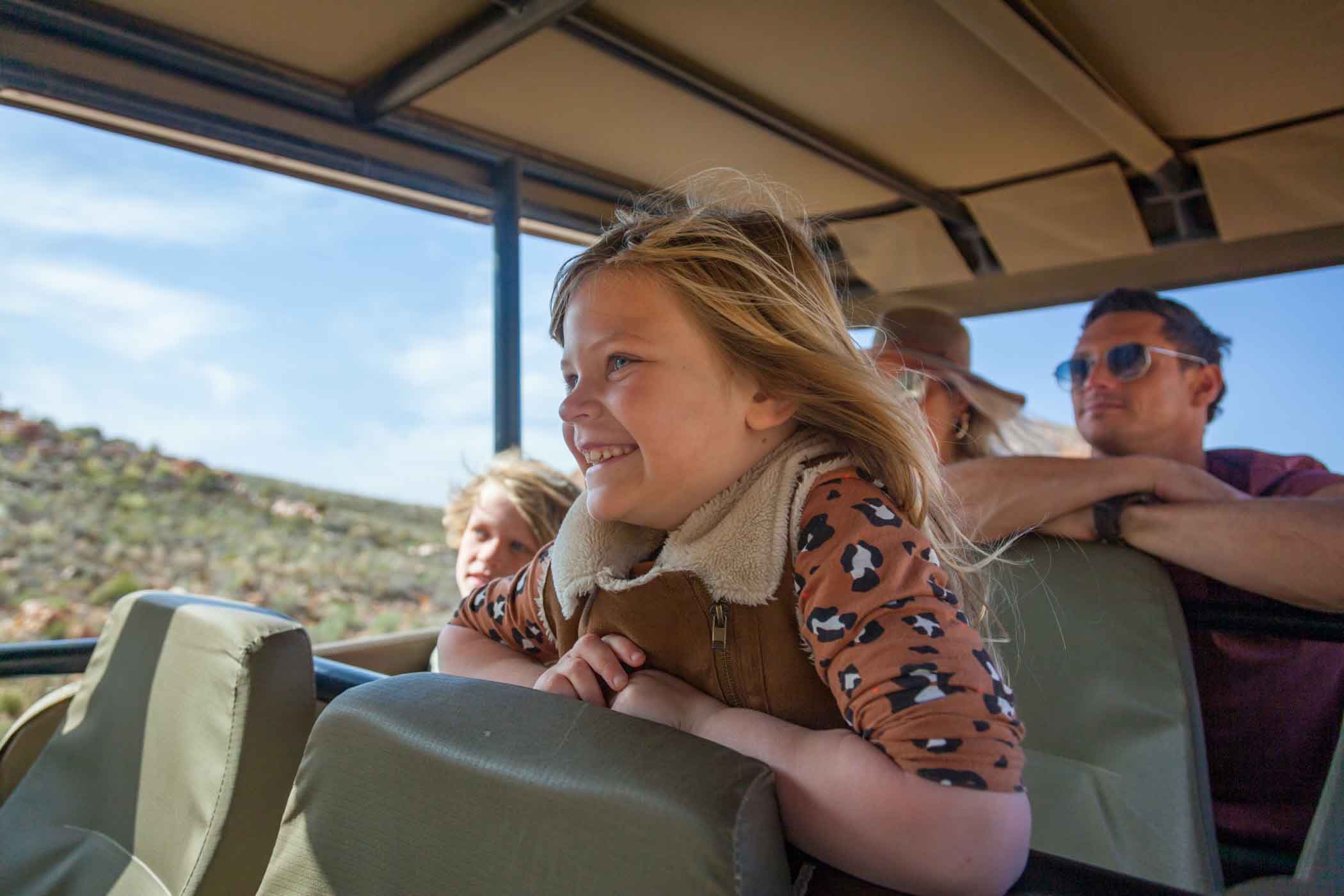 Children enjoying a ride in the open safari vehicle as part of Aquila's children policy.