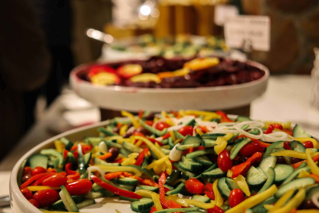 Buffet-style food options at Aquila's restaurant. Image showcasing a selection of vegetable and meat dishes.