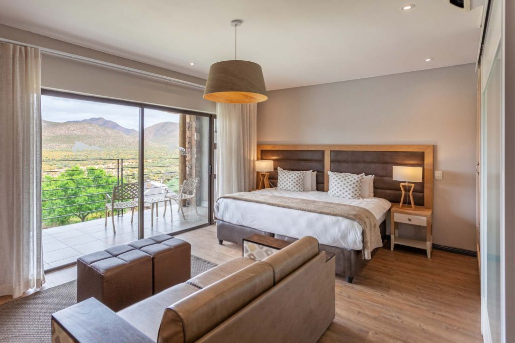 premier lodge room with balcony view over the reserve at Aquila Private Game Reserve and Spa: the best Cape Town safari and Big 5 destination